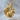 Sitting Squirrel Pendant, gold vermeil, product photo on stone
