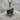 Skull Beret Pendant, oxidized silver, product photo angled on stone
