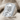 Crossed Axes Skull Ring, polished silver, angled view on fabric