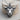 Nose Ring Bull Head Pendant, oxidized silver, product photo on wood block