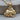 Crouching Rabbit Pendant, gold vermeil, product photo on wood