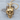 Middle Finger Skull Pendant, gold vermeil, front view on wood