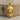 Wolf and Ram Pendant, gold vermeil, product photo on wood block