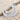 Scroll Crescent Star Pendant, polished, angled view on sand with driftwood