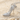 Stiletto High Heel Pendant, polished silver, angled view on sand