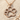 Paw Print Pendant, rose gold, front view on sand