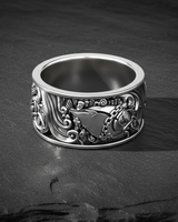 Detailed close-up of wealth fish ring featuring chain and money symbol on oxidized silver band