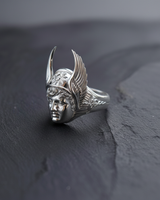 Close-up of Greek god Hermes face on a silver ring highlighting the sunburst helmet detail and classical sculpture style
