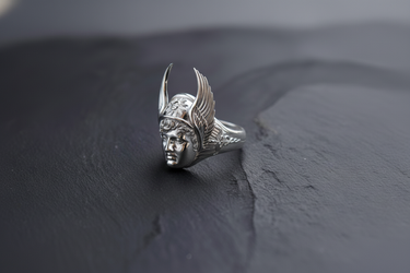 Close-up of Greek god Hermes face on a silver ring highlighting the sunburst helmet detail and classical sculpture style