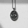 Oval 925 sterling silver Artemis pendant featuring goddess of the hunt with bow and stags on textured white background