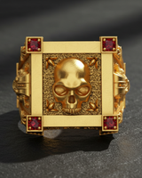 Gold vermeil silver vampire skull ring featuring red corner stones and textured square face