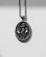 Oxidized 925 sterling silver Artemis pendant with intricate huntress and deer design on white textured surface