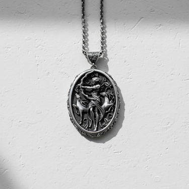 Oxidized 925 sterling silver Artemis pendant with intricate huntress and deer design on white textured surface