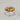 Gold vermeil death claddagh ring featuring skeletal hands holding a skull on neutral background