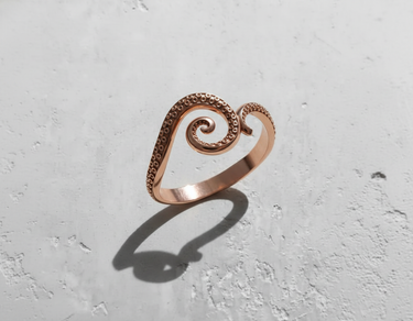 Rose gold plated 925 sterling silver octopus tentacle ring featuring detailed suckers and spiral design