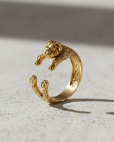 Gold vermeil bulldog ring featuring adjustable hugging paws design on light background