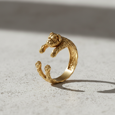 Gold vermeil bulldog ring featuring adjustable hugging paws design on light background