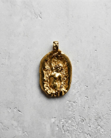 14K gold vermeil self made woman pendant featuring a female figure sculpting herself on concrete background