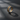 Two-tone silver tree branch ring featuring intertwined gold colored roots and silver rails on dark textured background