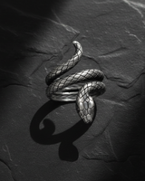 Side profile of handcrafted silver snake ring displaying realistic head detail and oxidized finish with shadow
