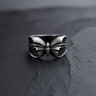 Front view of oxidized 925 sterling silver butterfly ring showing realistic body and spread wings design on slate surface