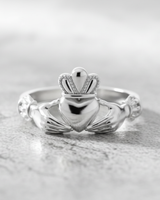 Angled close-up of sterling silver Celtic Claddagh ring showing intricate crown and heart details