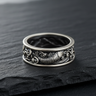 Oxidized 925 sterling silver koi wave ring with detailed fish scales on textured black slate