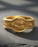 Close-up of gold vermeil koi fish ring featuring yin yang carp design on dark textured background