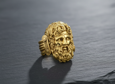Gold vermeil Zeus ring featuring detailed bearded face of Greek god Jupiter on dark stone background