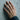 Pave Latin Cross Ring worn on model hand against concrete wall