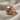 Round Skull Signet Ring, rose gold plated silver, angled view on fabric