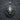 Close-up of handcrafted sterling silver lion head pendant on a dark textured background highlighting fierce features