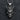 Close-up of the gothic king skull pendant showing the dark oxidized silver details and rugged finish on dark texture