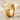 Exquisite floral band ring with gold vermeil finish resting on white beach sand surrounded by tiny natural seashells
