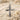 Detailed close-up of cross pendant design showcasing intricate stone setting and curves