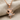 Dancing Doll Pendant, rose plated silver, front view on fabric