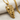 Double Horse Skull Pendant, gold vermeil, angled view on fabric