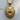 Detailed front view of gold vermeil grizzly bear pendant resting on a wooden surface highlighting meticulous craftsmanship