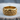 Close-up of the luxurious gold vermeil spiral wave ring displaying detailed 3D filigree on a natural wood slice