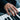Men's hand playing a keyboard while wearing the bold sterling silver pride statement ring with triangle symbol