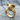 Close-up of 925 sterling silver bull head ring with gold finish resting on a textured wooden tree stump