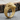 Close-up of premium eagle head ring resting on rustic wooden bark highlighting its detailed raptor design