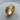 Detailed view of the 14K gold vermeil twisted rope ring resting gracefully on a textured circular wooden log slice.