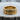 14K gold vermeil razor blade ring resting beautifully on a textured wooden surface highlighting the unique design.