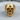 Detailed skull jaw ring in gold vermeil resting on a textured wooden surface, highlighting premium 925 sterling silver base.