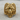 Close-up of the striking God Pan ring showcasing majestic horns and intricate facial details on a wooden surface