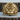 Close-up of handcrafted gorilla king ring resting on a textured wooden log highlighting majestic details