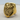 Close-up of the king skull ring in gold vermeil resting on a textured wooden surface showcasing 3D art