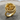 Macro view of handcrafted gold vermeil serpent rose ring resting beautifully on a textured wooden tree slice