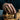 Lifestyle shot of detailed wraith skull ring worn on a man's hand while moving a chess piece on a wooden board